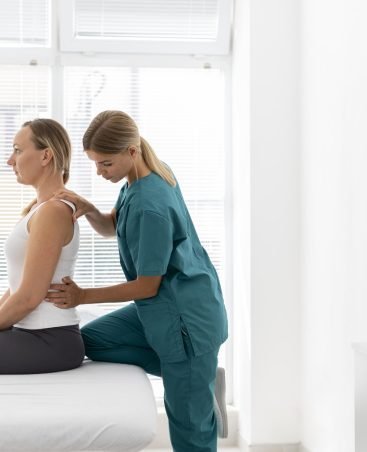 young-physiotherapist-helping-patient-with-back-problems
